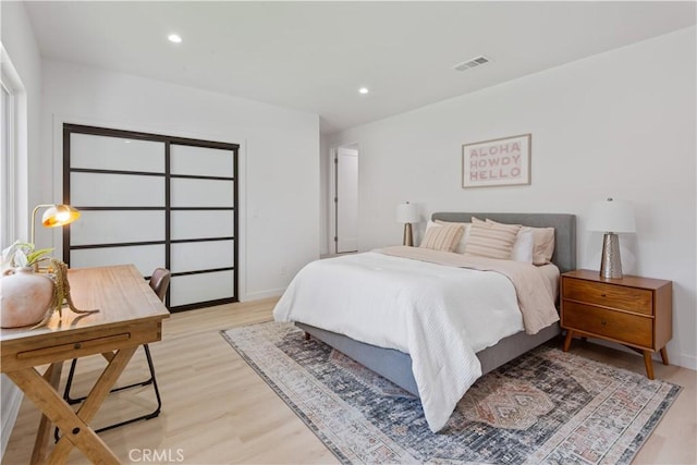 bedroom featuring baseboards, recessed lighting, visible vents, and light wood-type flooring