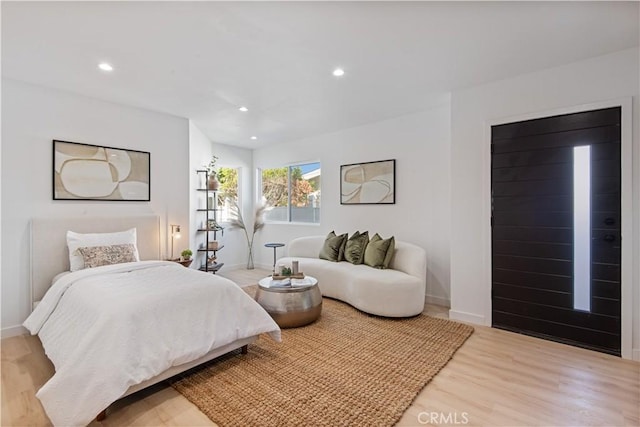 bedroom with light wood finished floors, baseboards, and recessed lighting