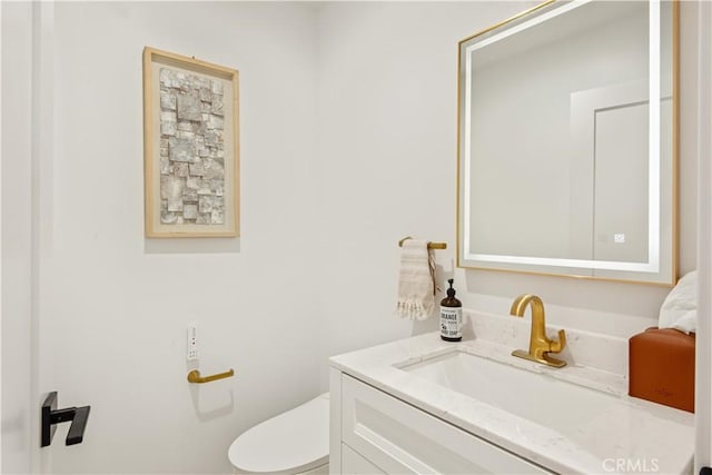 half bath with vanity and toilet