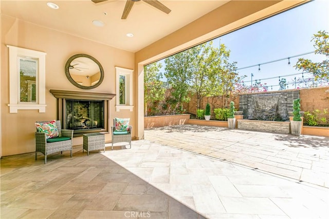 20512 W Esmeralda Ln, Porter Ranch, CA 91311 - fenced backyard featuring a patio, ceiling fan, and an outdoor fireplace