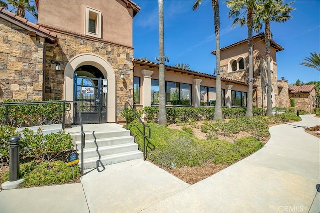 20512 W Esmeralda Ln, Porter Ranch, CA 91311 - view of exterior entry featuring stone siding and stucco siding