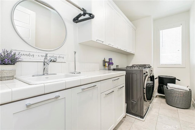 20512 W Esmeralda Ln, Porter Ranch, CA 91311 - washroom featuring cabinet space, washer and dryer, and light tile patterned flooring