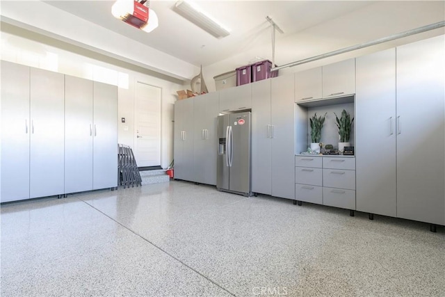 20512 W Esmeralda Ln, Porter Ranch, CA 91311 - garage with stainless steel fridge with ice dispenser and a garage door opener