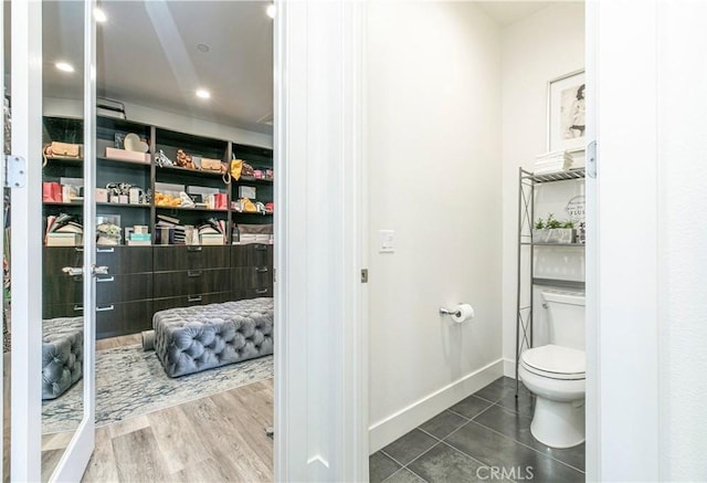 20512 W Esmeralda Ln, Porter Ranch, CA 91311 - bathroom featuring toilet, baseboards, and tile patterned flooring