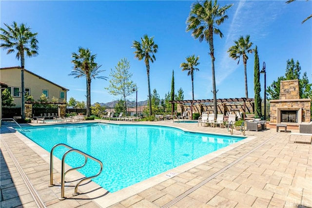 20512 W Esmeralda Ln, Porter Ranch, CA 91311 - community pool with a patio area, a mountain view, and an outdoor stone fireplace