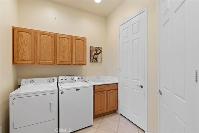 5536 Breckenridge Ave, Banning, CA 92220 - washroom with washer and clothes dryer, cabinet space, and light tile patterned flooring