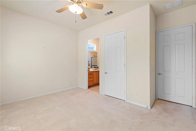 5536 Breckenridge Ave, Banning, CA 92220 - unfurnished bedroom with light carpet, baseboards, ensuite bathroom, and a ceiling fan