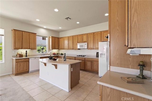5536 Breckenridge Ave, Banning, CA 92220 - kitchen featuring white appliances, light countertops, a center island with sink, recessed lighting, and light tile patterned flooring