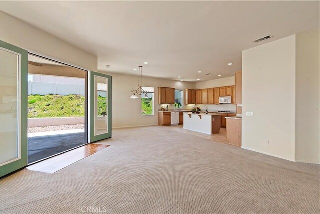 5536 Breckenridge Ave, Banning, CA 92220 - unfurnished living room featuring light colored carpet, baseboards, and recessed lighting