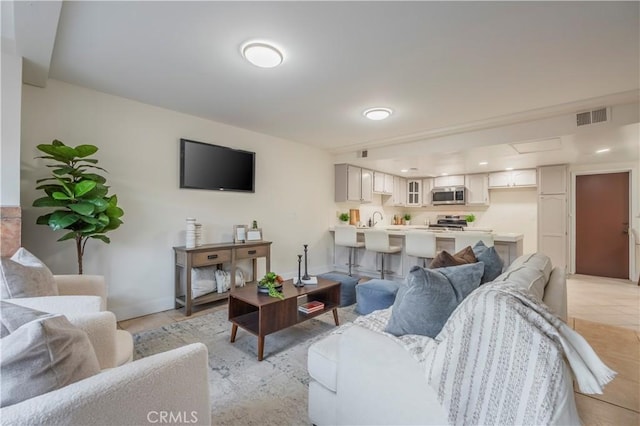 living area with visible vents and baseboards