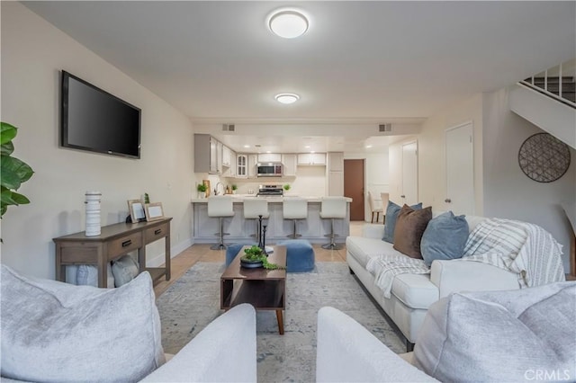 living room with visible vents and baseboards