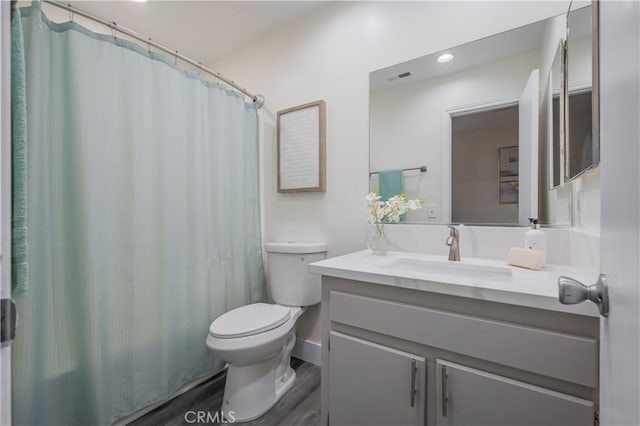 full bathroom with toilet, visible vents, recessed lighting, wood finished floors, and vanity