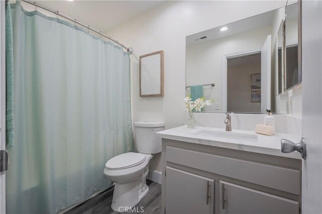 11249 Ferina St, Norwalk, CA 90650 - full bath with toilet, wood finished floors, vanity, and recessed lighting