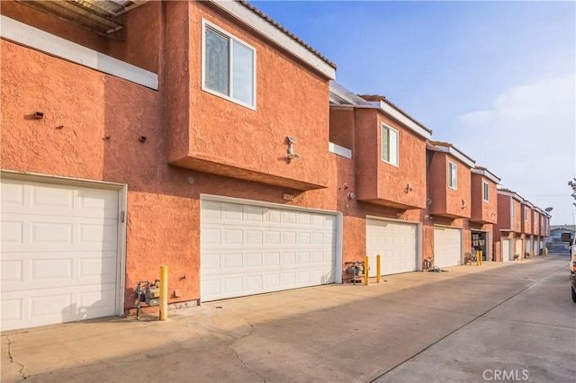view of property featuring driveway and a garage