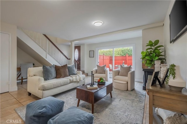living room with stairway and tile patterned flooring