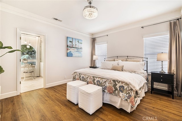 bedroom featuring baseboards, crown molding, hardwood / wood-style flooring, and multiple windows