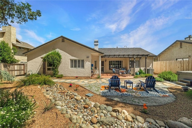 back of property with a fenced backyard, a patio area, and stucco siding