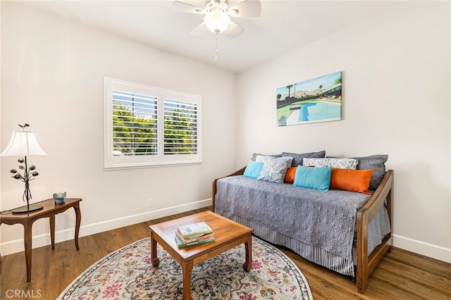 bedroom featuring ceiling fan, baseboards, and wood finished floors