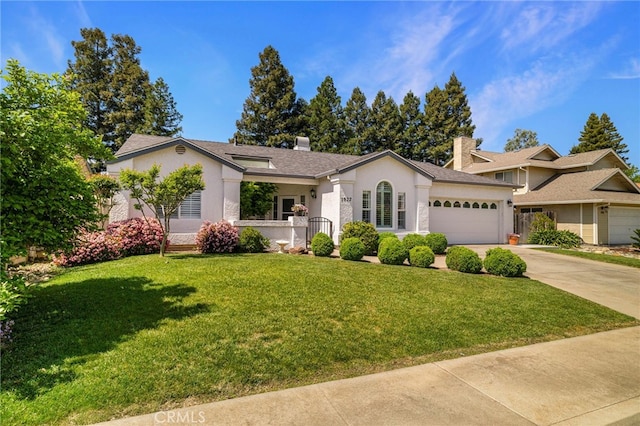 ranch-style house featuring a chimney, a front lawn, stucco siding, an attached garage, and concrete driveway