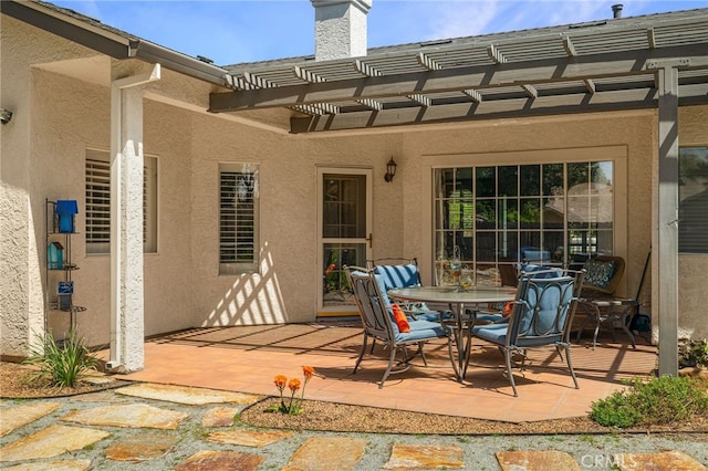 view of patio / terrace with a pergola and outdoor dining space