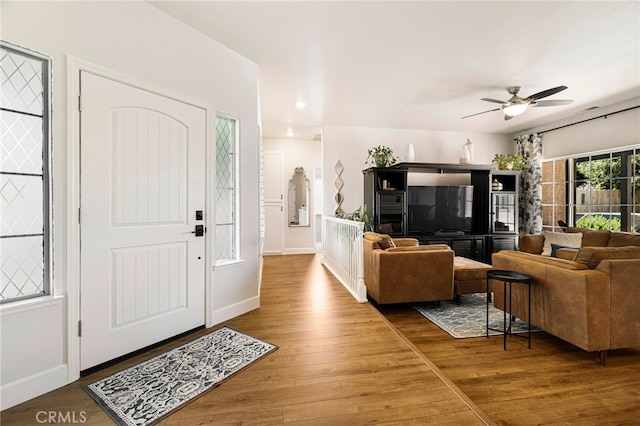 foyer featuring baseboards, a ceiling fan, wood finished floors, and recessed lighting