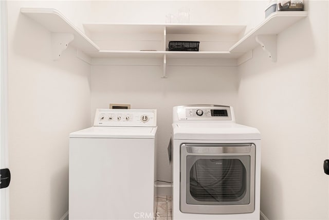 laundry area with separate washer and dryer and laundry area