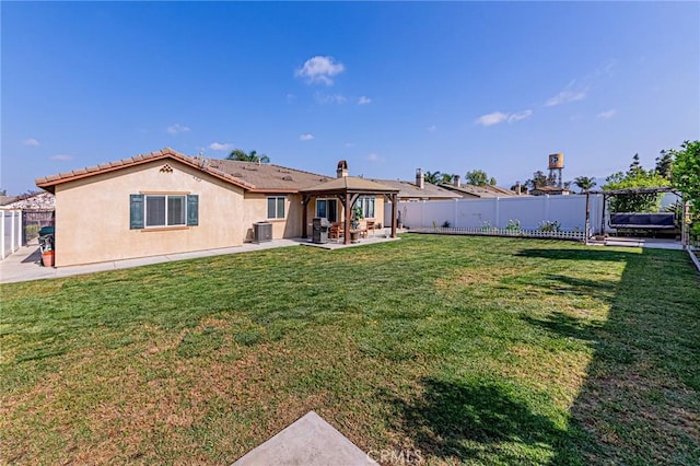 rear view of property with a patio, central AC, a gazebo, stucco siding, and fence