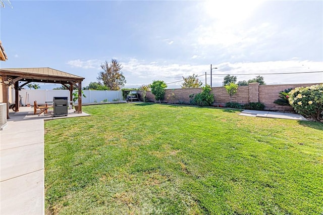 view of yard featuring a patio, a gazebo, and a fenced backyard