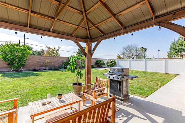 view of patio / terrace with a gazebo, a fenced backyard, and grilling area