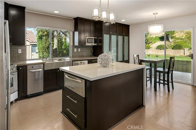 kitchen featuring decorative backsplash, a sink, appliances with stainless steel finishes, and a warming drawer