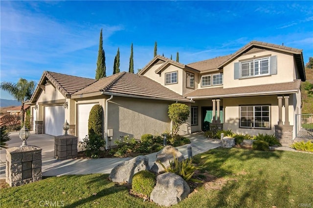 view of front of house featuring a front lawn, stucco siding, an attached garage, a tile roof, and driveway