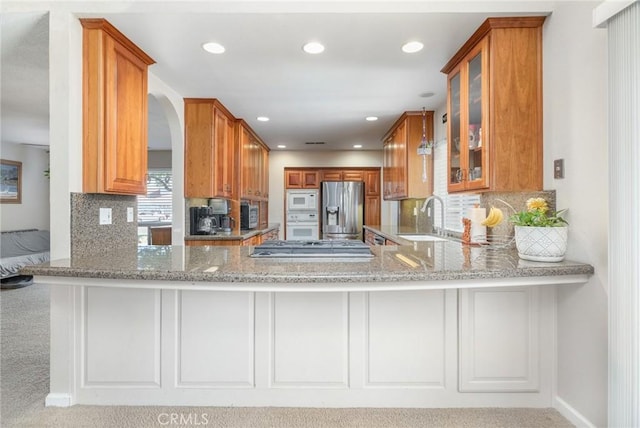 344 E Birch Ave, Hanford, CA 93230 - kitchen with stainless steel appliances, a peninsula, a sink, and glass insert cabinets
