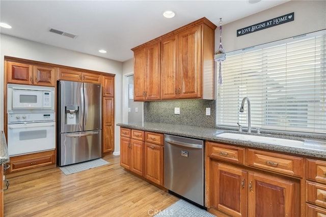 344 E Birch Ave, Hanford, CA 93230 - kitchen featuring brown cabinets, appliances with stainless steel finishes, a sink, and visible vents