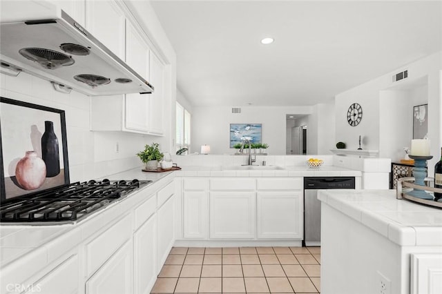 2811 Westbourne Pl, Rowland Heights, CA 91748 - kitchen featuring tile counters, appliances with stainless steel finishes, a peninsula, under cabinet range hood, and visible vents