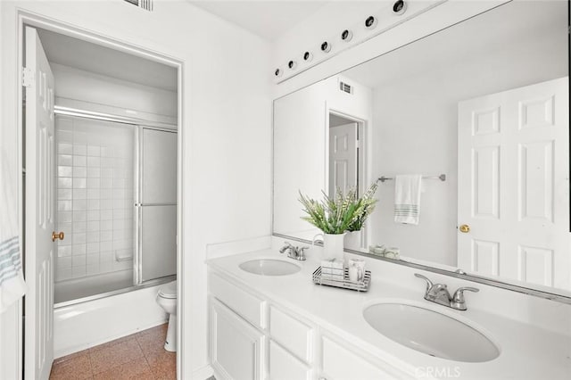 2811 Westbourne Pl, Rowland Heights, CA 91748 - bathroom with double vanity, combined bath / shower with glass door, toilet, and a sink