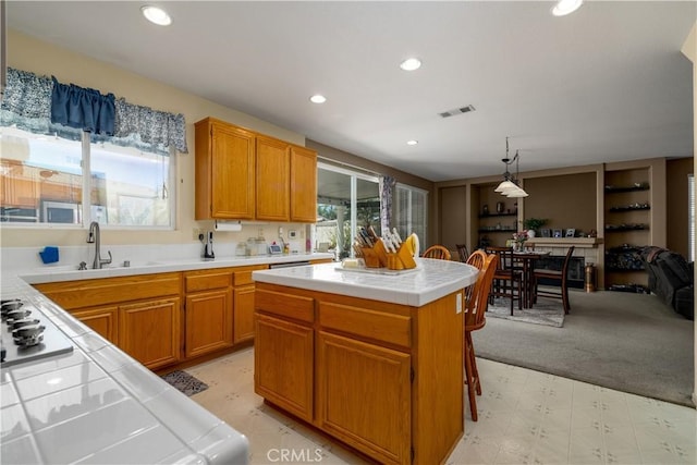 kitchen with recessed lighting, light floors, visible vents, tile countertops, and open floor plan