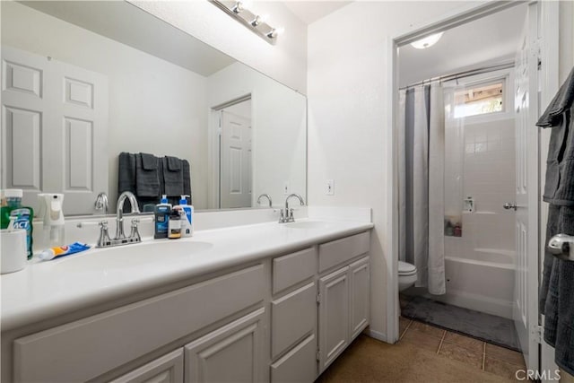 full bathroom with double vanity, toilet, shower / tub combo with curtain, and a sink