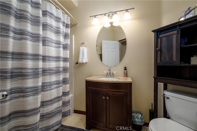 full bathroom featuring shower / bath combo, vanity, and toilet