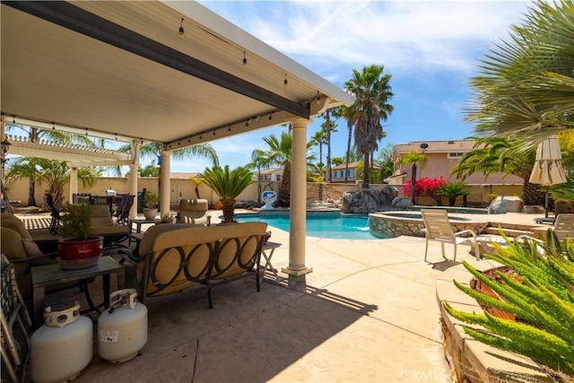 view of pool with a pergola, a pool with connected hot tub, a fenced backyard, and a patio