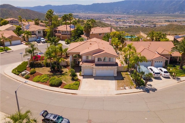 birds eye view of property with a residential view and a mountain view