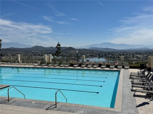 pool featuring fence and a mountain view