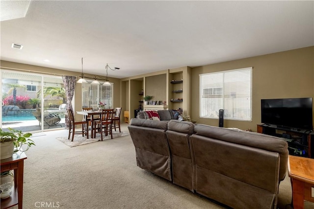 carpeted living area featuring visible vents