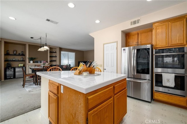 kitchen with tile counters, visible vents, stainless steel appliances, and recessed lighting