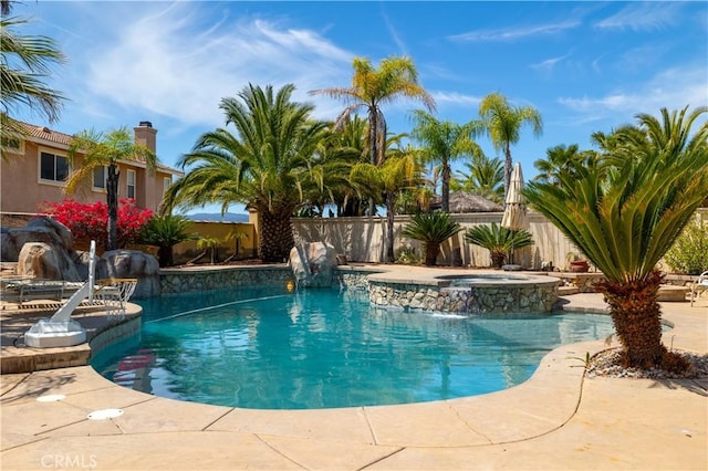 view of pool featuring a fenced backyard, a patio, a fenced in pool, and an in ground hot tub
