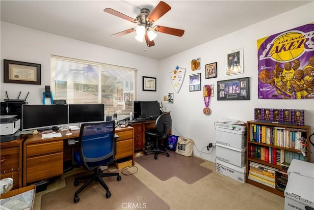 home office featuring light colored carpet and a ceiling fan
