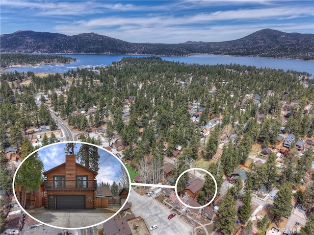 drone / aerial view with a water and mountain view
