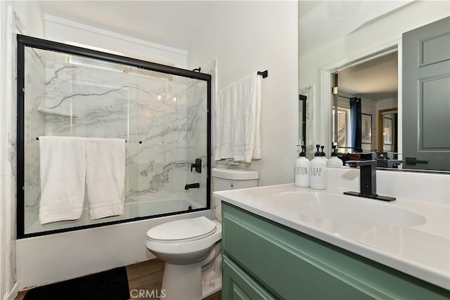 full bath featuring vanity, shower / bath combination with glass door, and toilet