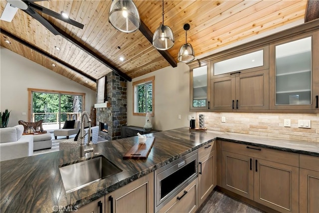 867 Clement St, South Lake Tahoe, CA 96150 - kitchen featuring wood ceiling, open floor plan, backsplash, stainless steel microwave, and dark stone countertops