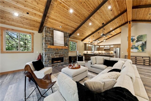 867 Clement St, South Lake Tahoe, CA 96150 - living room featuring a wooden ceiling with exposed beams, light wood finished floors, a stone fireplace, recessed lighting, and high vaulted ceiling