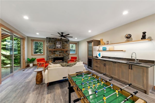 867 Clement St, South Lake Tahoe, CA 96150 - playroom with a ceiling fan, bar with sink, a stone fireplace, wood finished floors, and recessed lighting